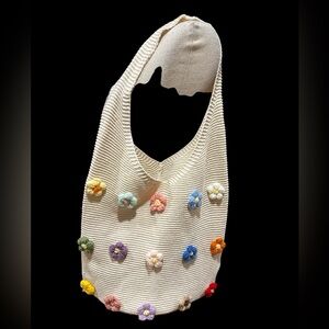 Knit hobo bag with 3 dimensional knitted Crochet floral accents in cream.